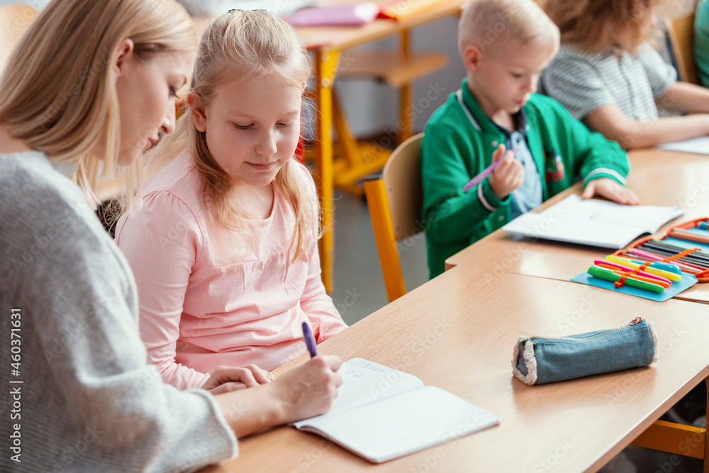Helpful teacher helps students to solve a difficult geography task Helpful teacher helps students to solve a difficult geography task