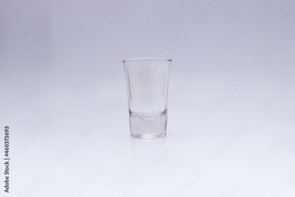 Empty ouzo glass isolated on white background