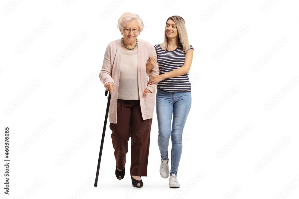 Full length portrait of a kind young woman helping an elderly woman walking with a cane Full length portrait of a kind young woman helping an elderly woman walking with a cane