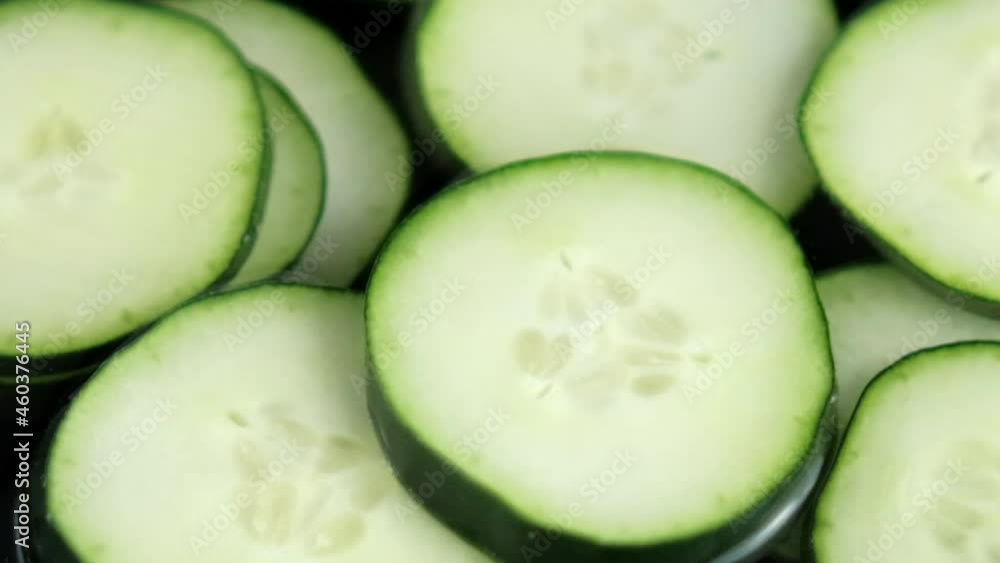 Close-up of group of fresh cucumber slices floating in liquid Close-up of group of fresh cucumber slices floating in liquid