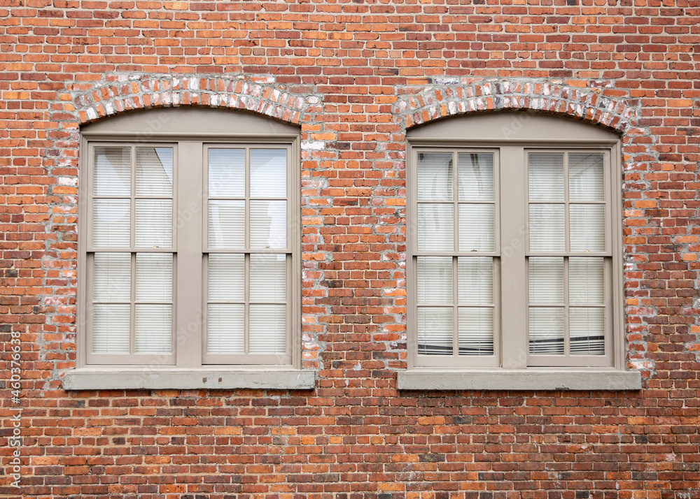 old brick wall with symmetrical windows