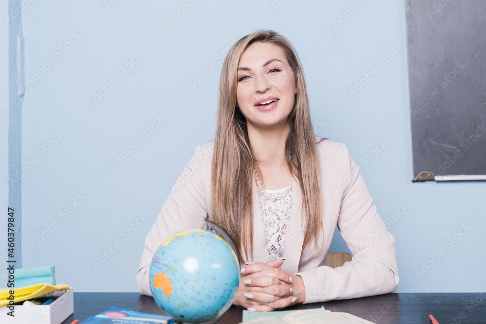 Beautiful confident teacher in a classroom. Beautiful confident teacher in a classroom.