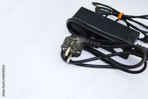 Old used laptop charger isolated on white background.