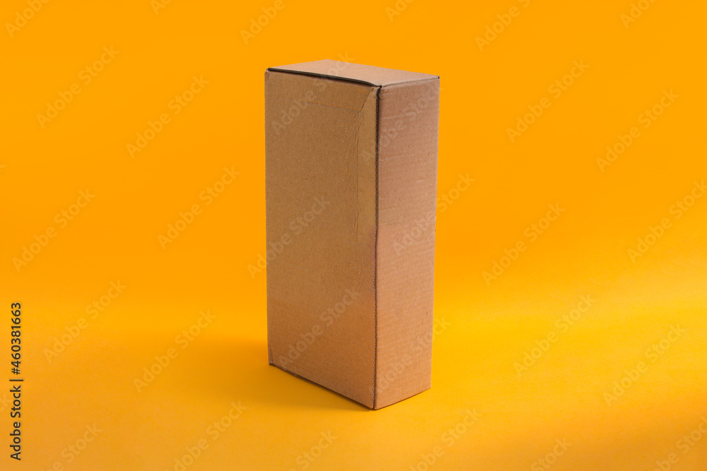 Brown Cardboard box isolated on orange background Brown Cardboard box isolated on orange background