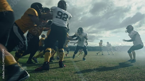 American Football Field: Two Professional Teams Clash, Trying to Score Touchdown Points. Defense and Offense Brutally Compete for the Ball, Tackle Each other. Dramatic Cinematic Slow Motion Shot