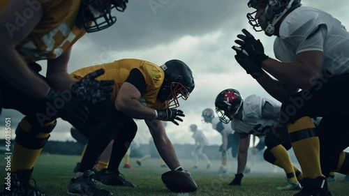 American Football Championship Start Teams Ready: Professional Players, Aggressive Face-off, Start Pushing, Tackling. Competition Full of Brutal Energy, Skill. Cinematic Slow Motion. Dramatic Sport photo