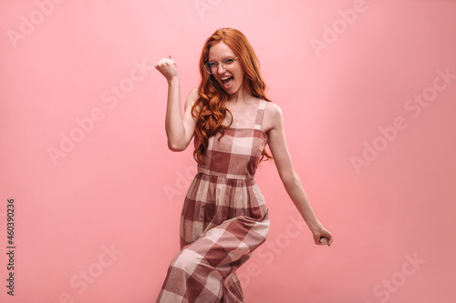 Foto Young slim european girl with red long hair, joyful on pink background