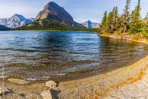 The Rocky Shoreline of Swiftcurrent Lake with Grinnel Point, Glacier National Park, Montana, USA photo