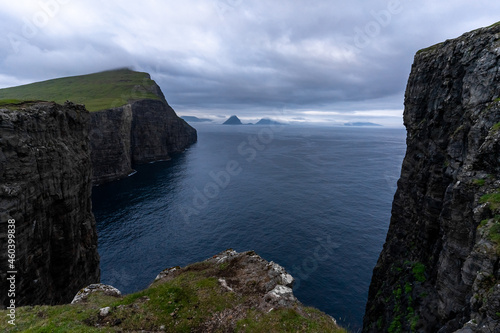 Beautiful aerial view of the Bøsdalafossur waterfall and Trælanípan magnificent landmarks in the Faroe Islands