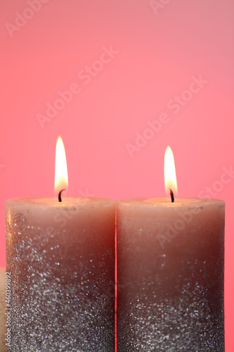 Candles set. Burning candles on a pink background. Festive candles. Flame candles close-up.Religion and culture