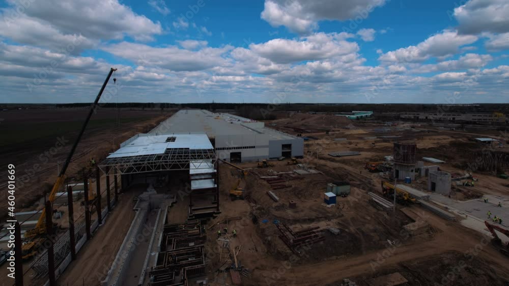At construction site where a new, modern plant is being built, a lot of equipment works - cranes, tractors, excavators, trucks, hoists, as well as teams of workers. Accelerated shooting, time-lapse At construction site where a new, modern plant is being built, a lot of equipment works - cranes, tractors, excavators, trucks, hoists, as well as teams of workers. Accelerated shooting, time-lapse