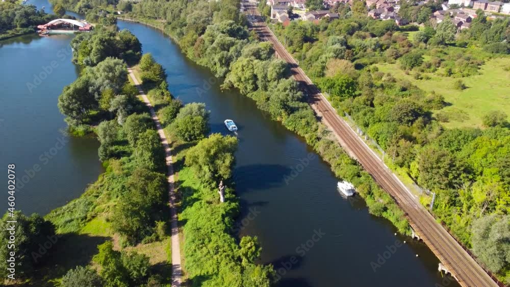 aerial shot of a yacht sailing in a canal during the day in Norwich, England aerial shot of a yacht sailing in a canal during the day in Norwich, England