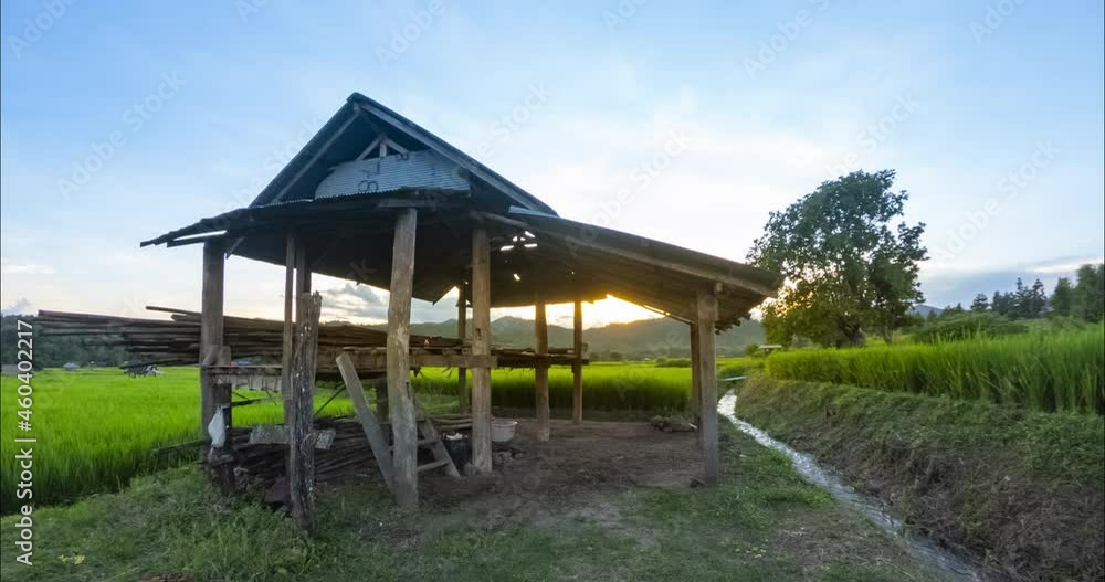 Time Lapse sun setting over the green paddy field at Mae Hong Son province Thailand, The view from the front of the hut with the sun was setting through the hut. Time Lapse sun setting over the green paddy field at Mae Hong Son province Thailand, The view from the front of the hut with the sun was setting through the hut.