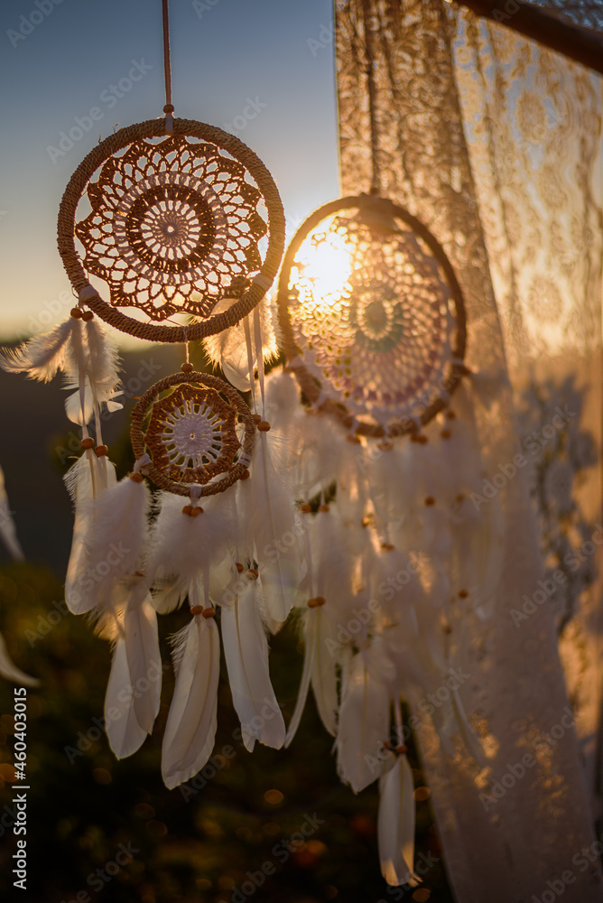 White Dreamcatcher in sunset sky, american native amulet