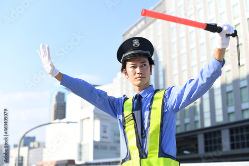 Foto 誘導棒を持つ交通誘導をするガードマンの男性