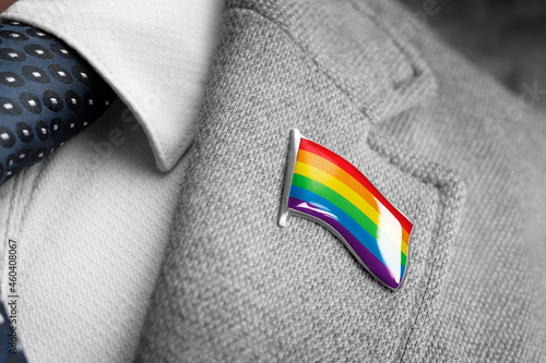 Metal badge with the flag of lgbt on a suit lapel photo