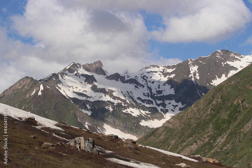 Beautiful scenery with clouds shadow on snow-covered mountains with clouds surrounding the mountains in a tourist spot Rattti Gali, Kashmir, Pakistan