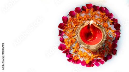 beautiful Diya in on flower bed for Diwali and Deepawali photo