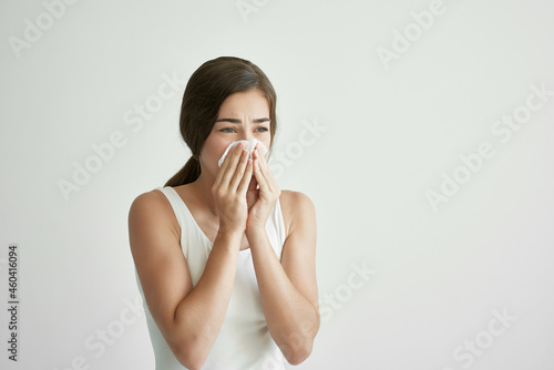 woman wiping her nose with a handkerchief allergy health problems virus
