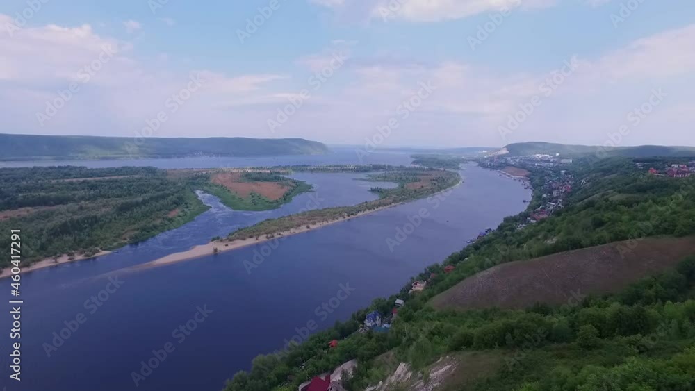 aerial view of natural landscape with wide river, island and mountains in horizon aerial view of natural landscape with wide river, island and mountains in horizon