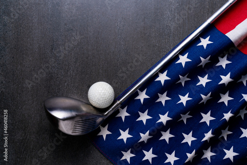 Golf ball with flag of USA or US on black table background