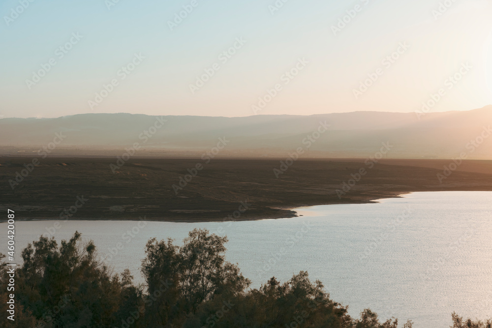 Sunrise over the Dead Sea on a foggy day. A view from Israel To Jordan Mountains. High quality photo
