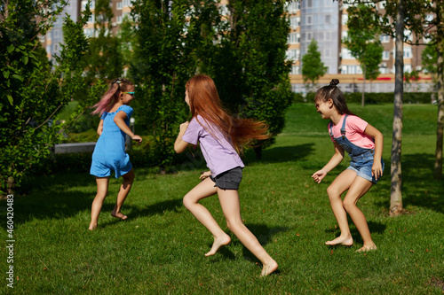 happy cute children girls run in the park