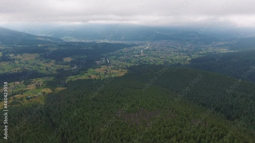 Aerial shot of a boundless valley in the Carpathian mountains covered with spruces Aerial shot of a boundless valley in the Carpathian mountains covered with spruces