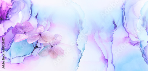 Creative image of pastel blue and purple Hydrangea flowers on artistic ink background. Top view with copy space