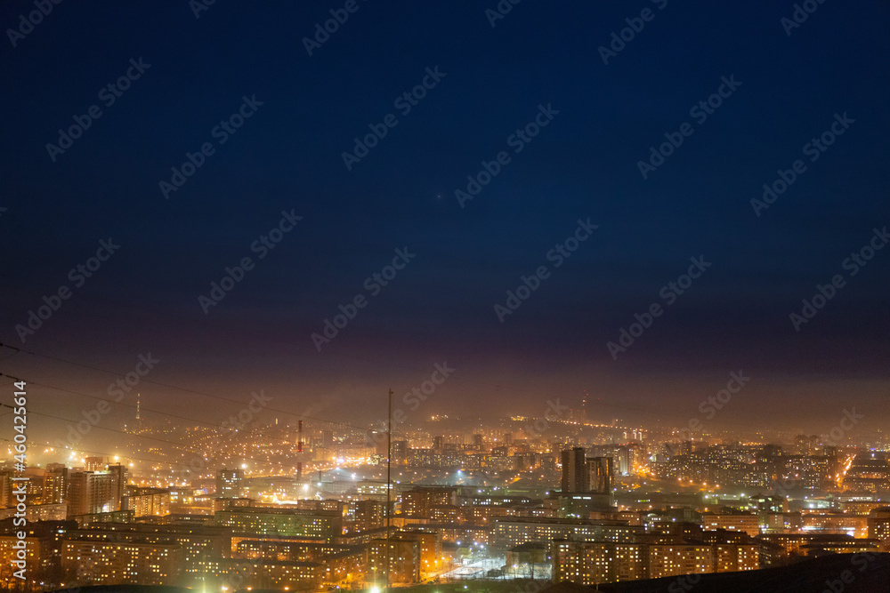 Night view of the Siberian city in winter. Krasnoyarsk, Russia. Air pollution.