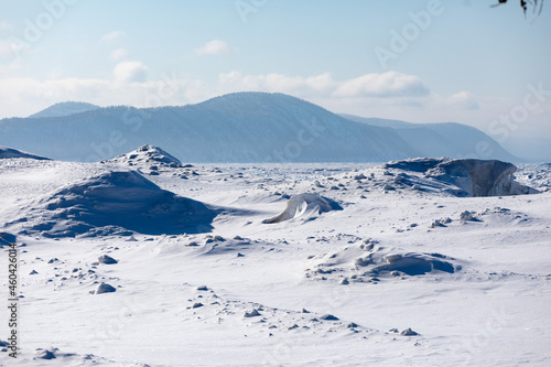Gremyachinsk, Baikal, Russia February 10, 2019. Wonderful winter snow-covered Siberian landscape in the blue shades of Lake Baikal. Ice hummocks. © Mikhail