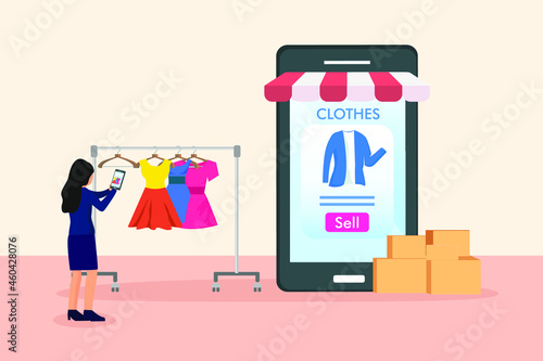 Woman taking picture of clothes to sell online on mobile phone apps
