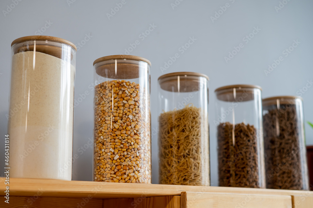 Glass jars with cereals in an eco friendly store. The concept of a grocery store without plastic disposable packaging Glass jars with cereals in an eco friendly store. The concept of a grocery store without plastic disposable packaging