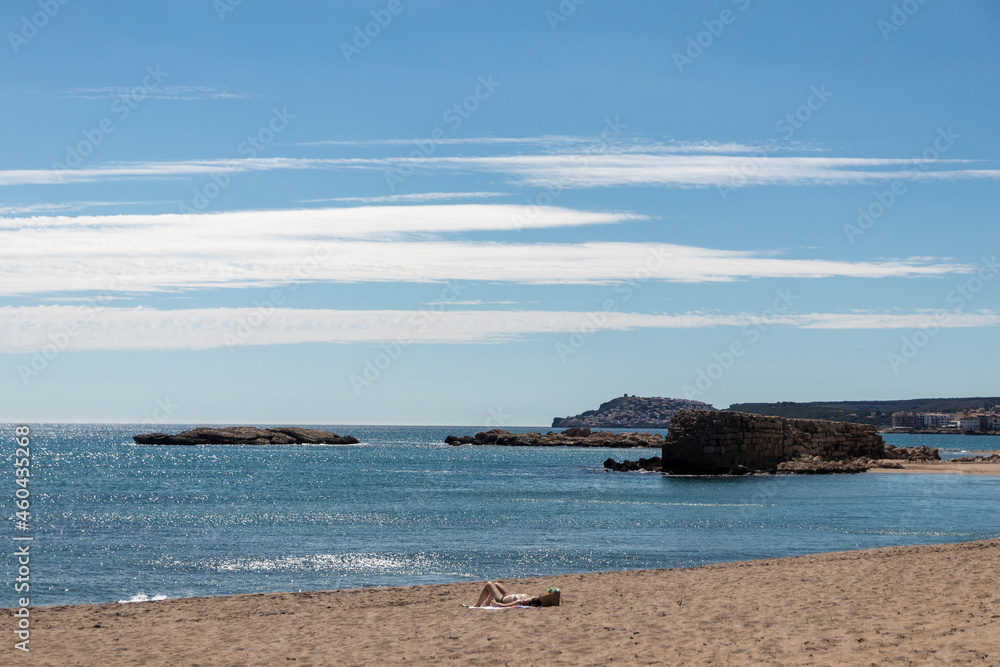 woman sunbathing topless on a lonely beach on the costa brava