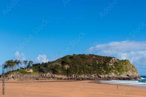 island of lekeitio at low tide a sunny day with a blue sky and sea