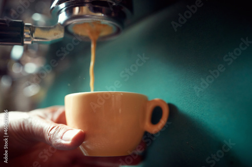 coffee pouring into cup.Close up