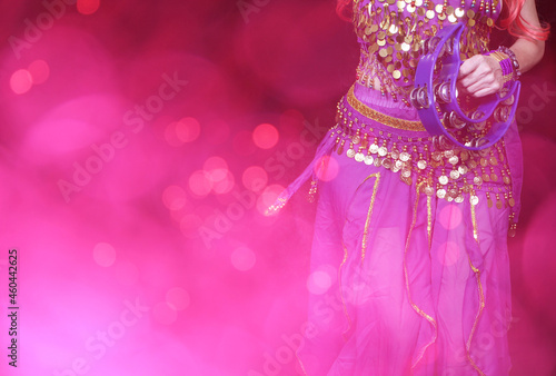 Billede på lærred Belly Dancer wearing purple dance costume close up with bokeh