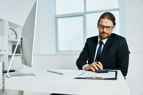 man in a suit documents in hand communication by phone Lifestyle