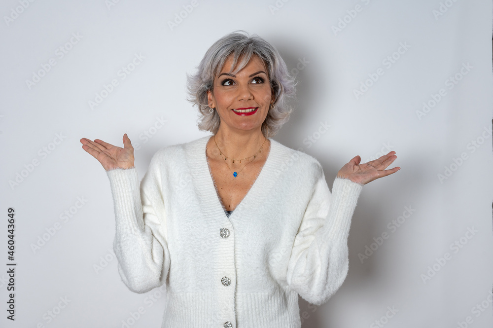 Adult woman with white hair smiling with open hands Adult woman with white hair smiling with open hands
