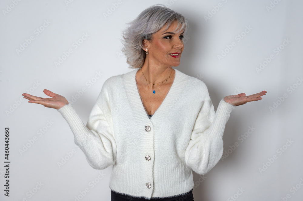 Adult woman with white hair smiling with open hands Adult woman with white hair smiling with open hands