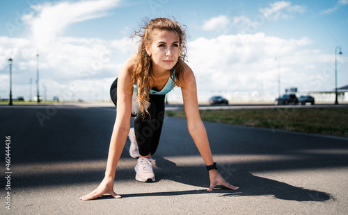 Cardio training for weight loss. Sports and clothing for women. Fitness in the city. A professional trainer does warm-up exercises before training. The athlete leads a healthy lifestyle.