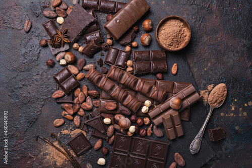 Chocolate background with lots of bars, nuts and cocoa beans