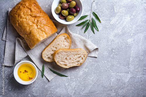 Bowl of delicious olives with oil and bread