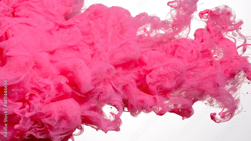 Pink cloud of ink on a white background. Awesome abstract background. Drops of pink ink in water. Pink watercolor ink in water on a white background.