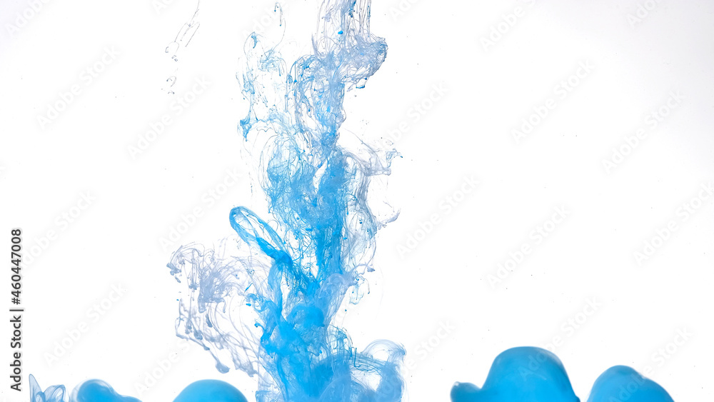 Colored cloud of ink on a white background. Blue and white watercolor ink in water on a white background. Beautiful abstract background.