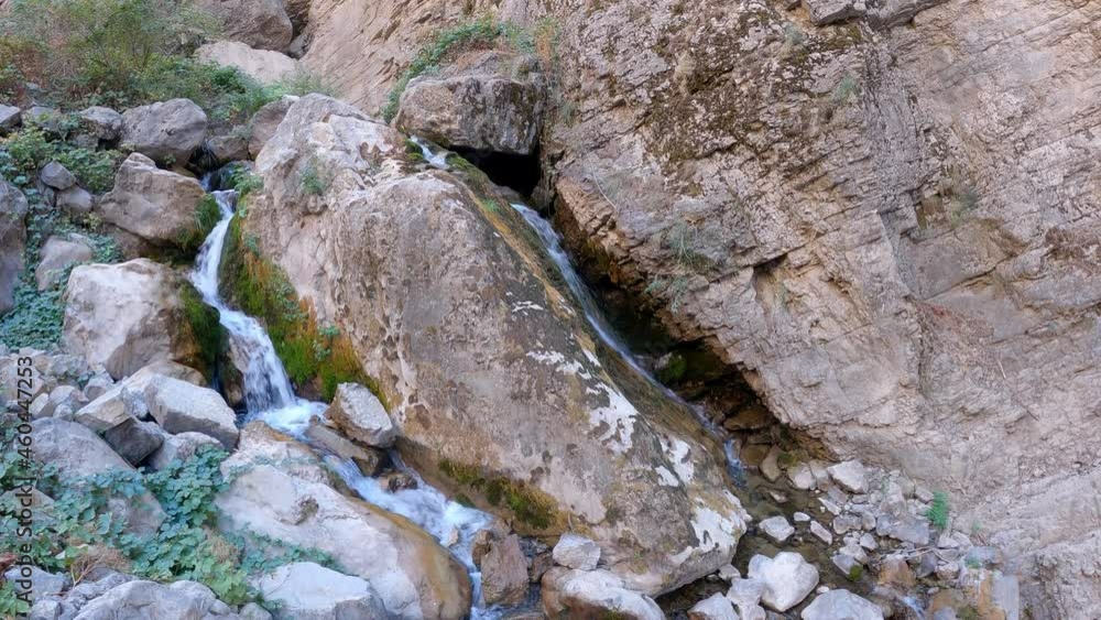 A foot-shaped stone from which water flows on both sides A foot-shaped stone from which water flows on both sides