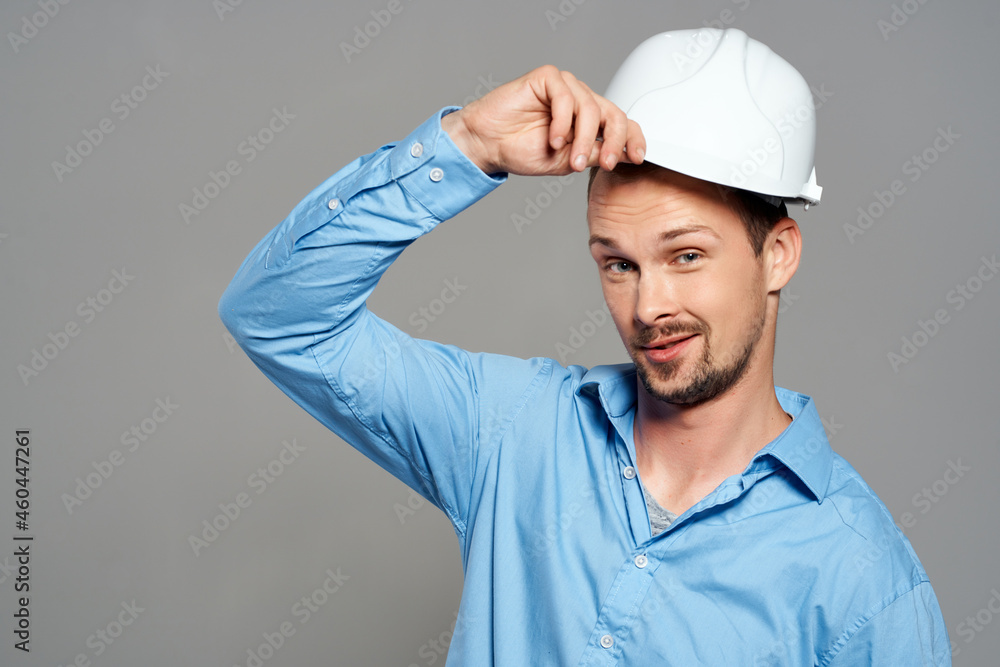 worker with drawings in hand hand gesture light background