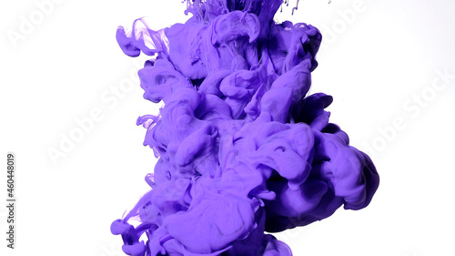 Purple paints are mixed in water. Colored cloud of ink on a white background. Purple watercolor ink in water on a white background.