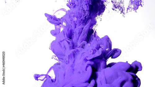 Fascinating abstract background. Purple paints are mixed in water. Colored cloud of ink on a white background.