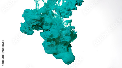Colored cloud of ink on a white background. Mint green watercolor ink in water on a white background. Beautiful abstract background.